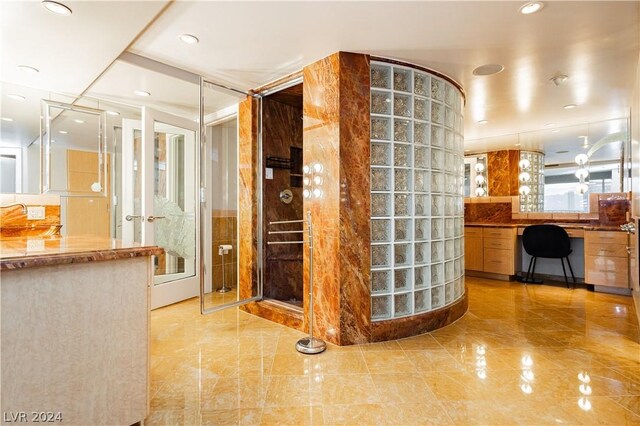 bathroom with vanity, walk in shower, and backsplash