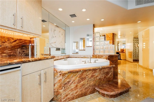 bathroom with recessed lighting, visible vents, vanity, and a bath