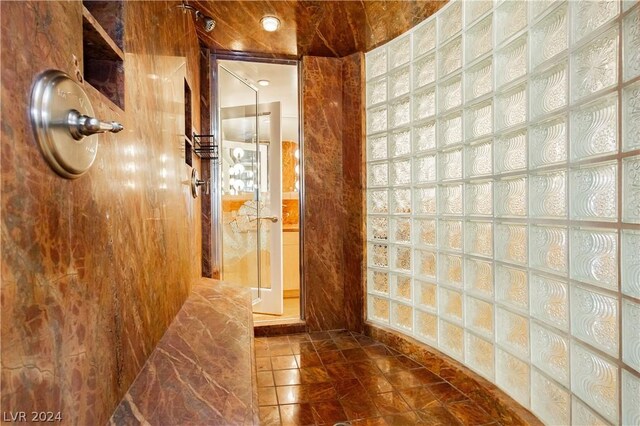 bathroom with walk in shower and tile patterned flooring