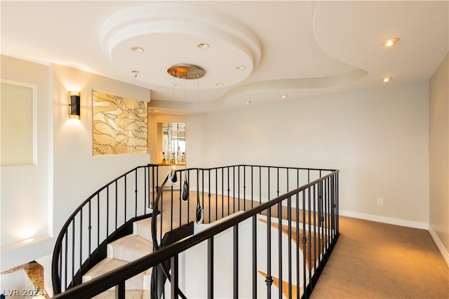 corridor with recessed lighting, baseboards, carpet flooring, and an upstairs landing