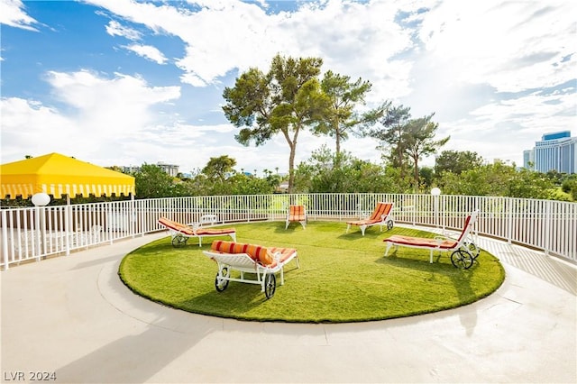 view of home's community featuring a yard and fence