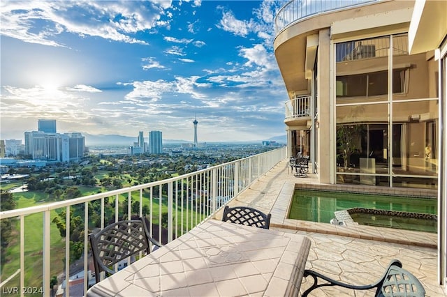 balcony featuring outdoor dining space and a view of city