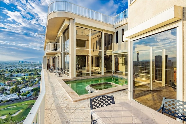 exterior space featuring an in ground hot tub and a patio area