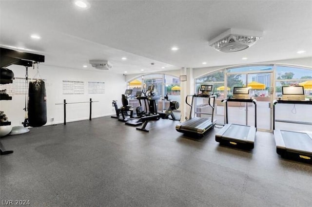 gym with recessed lighting, a textured ceiling, and baseboards