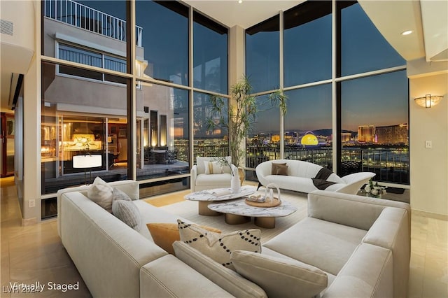 sunken living room with floor to ceiling windows, a fireplace, and visible vents