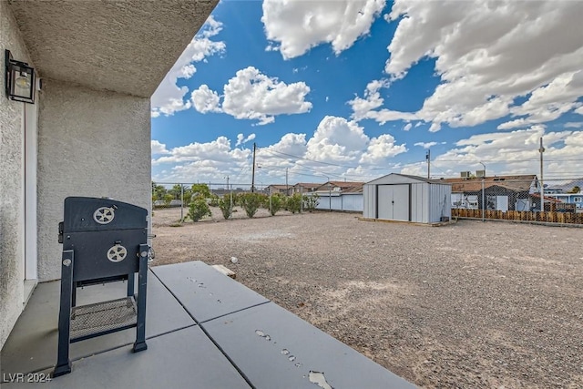 view of yard featuring a patio area and a storage unit