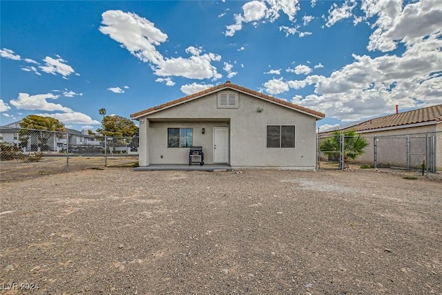 rear view of property featuring a patio area