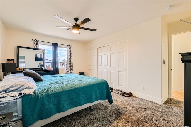 carpeted bedroom with ceiling fan and a closet