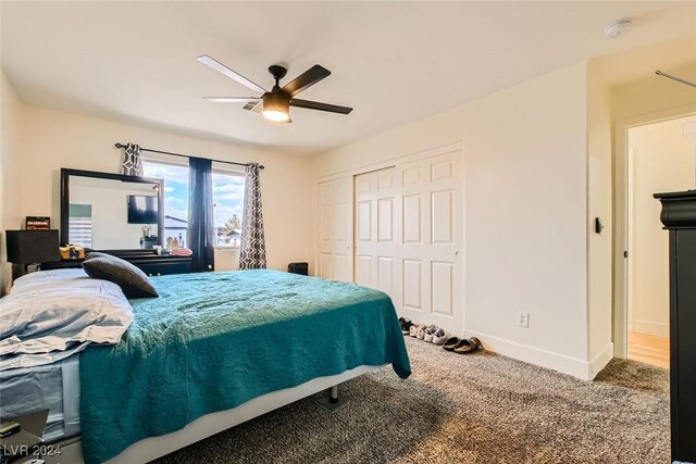 carpeted bedroom with ceiling fan and a closet