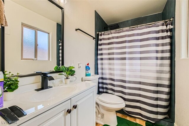 bathroom with toilet and vanity