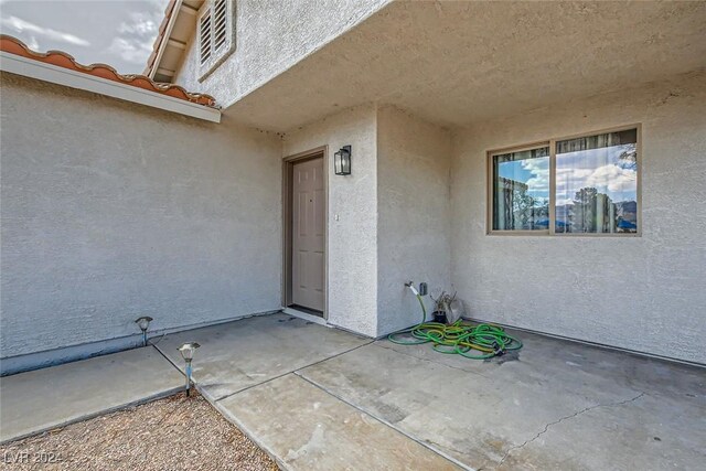 entrance to property featuring a patio