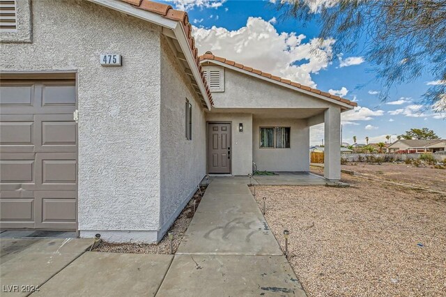 doorway to property with a garage