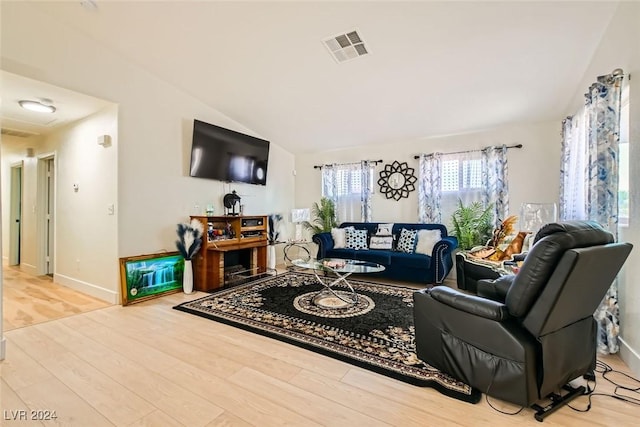 living room with lofted ceiling and light hardwood / wood-style floors