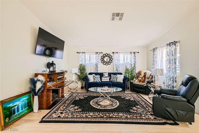 living room with lofted ceiling and light hardwood / wood-style flooring