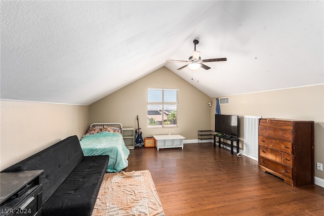 bedroom featuring hardwood / wood-style flooring, a textured ceiling, vaulted ceiling, and ceiling fan