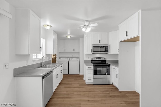 kitchen with white cabinetry, sink, washer and clothes dryer, and stainless steel appliances