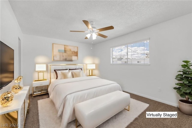 bedroom featuring dark carpet, a textured ceiling, and ceiling fan