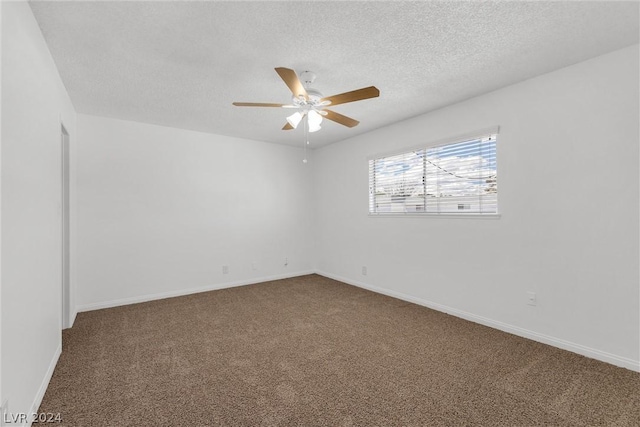 carpeted spare room featuring a textured ceiling and ceiling fan