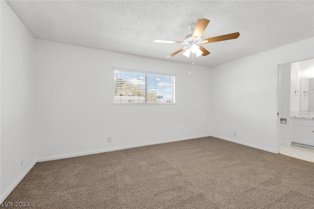 unfurnished room with light carpet, a textured ceiling, and ceiling fan