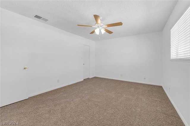 carpeted empty room with a textured ceiling and ceiling fan