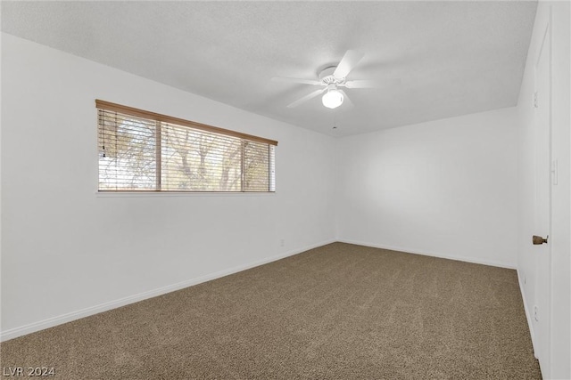 spare room featuring carpet floors and ceiling fan