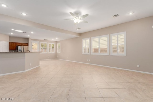 unfurnished living room featuring a ceiling fan, recessed lighting, visible vents, and baseboards