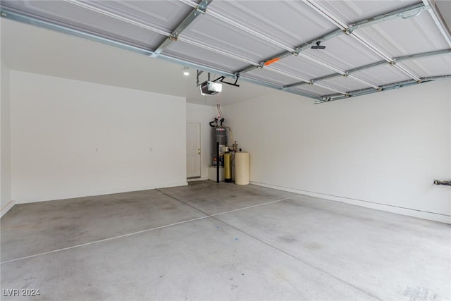 garage with water heater and a garage door opener