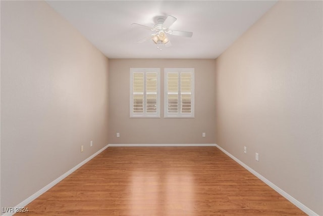 unfurnished room with light wood-style floors, ceiling fan, and baseboards