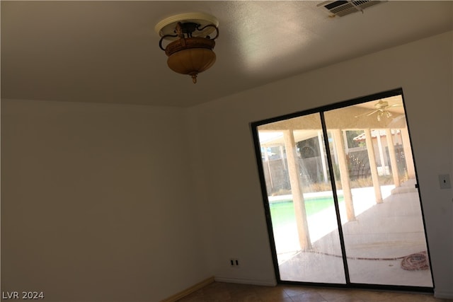 empty room featuring light tile patterned floors and a wealth of natural light