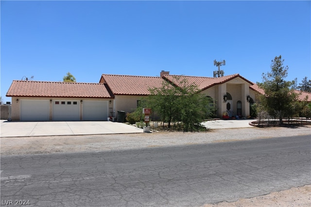 mediterranean / spanish-style house with a garage