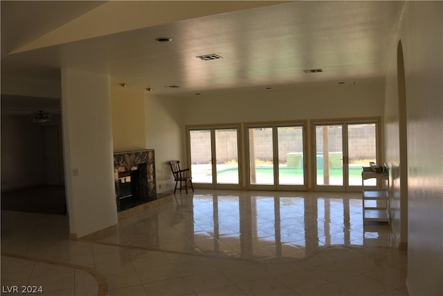 tiled empty room featuring a fireplace