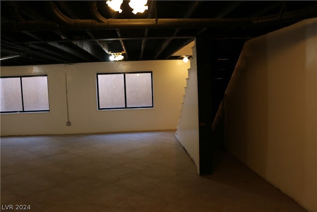 basement with tile patterned flooring and plenty of natural light