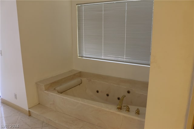 bathroom with tile patterned flooring and tiled bath