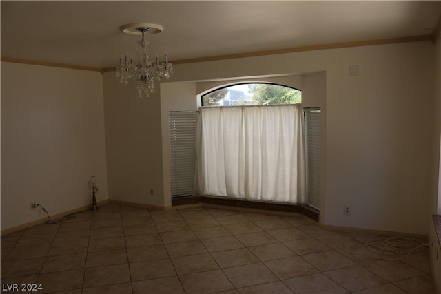 unfurnished room featuring an inviting chandelier, tile patterned flooring, and ornamental molding