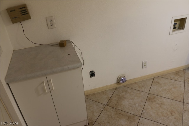 laundry room with light tile patterned flooring and hookup for a washing machine