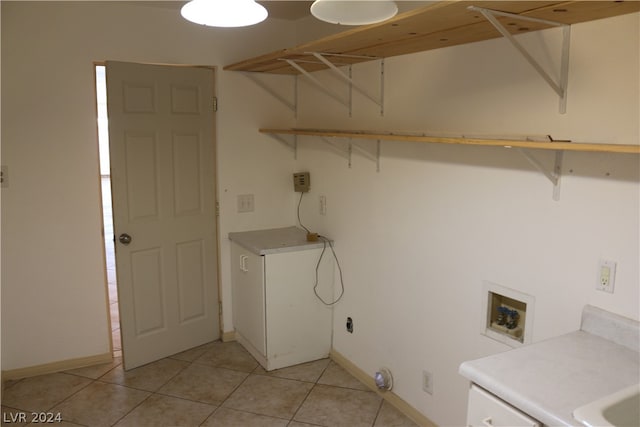 washroom featuring hookup for a washing machine and light tile patterned floors