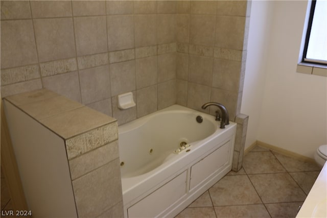 bathroom with tile patterned floors, tile walls, toilet, and a tub