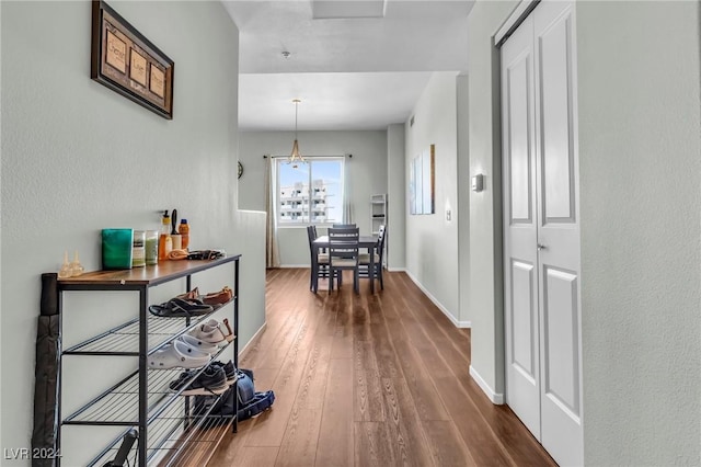 hall with dark wood-style floors and baseboards