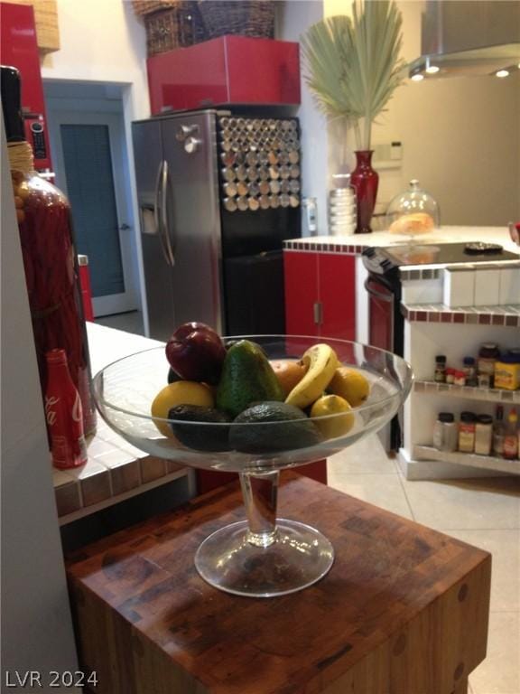 kitchen with light tile patterned flooring and stainless steel fridge with ice dispenser