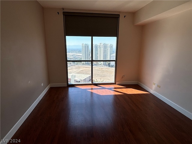 spare room with wood-type flooring