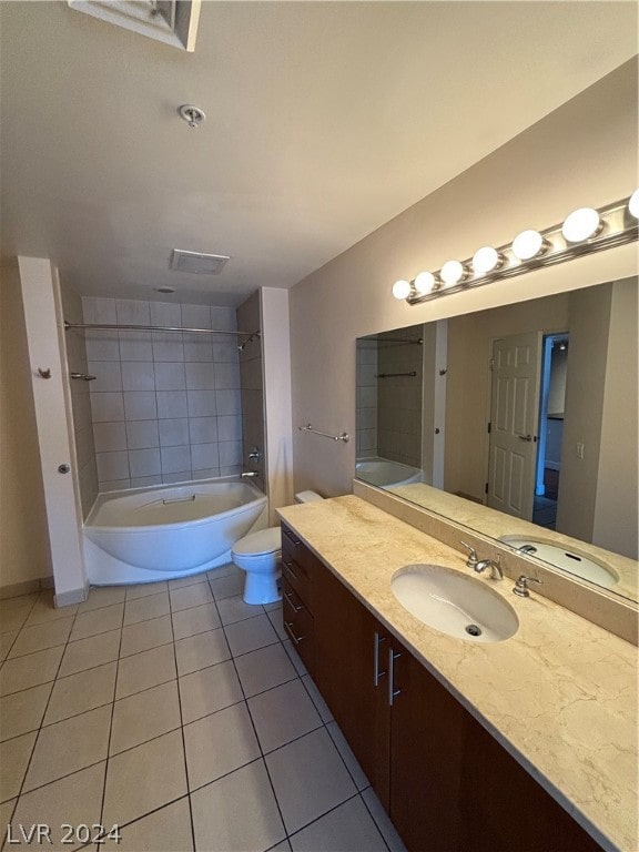 bathroom with vanity, tile patterned floors, and toilet