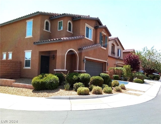 mediterranean / spanish-style home featuring a garage