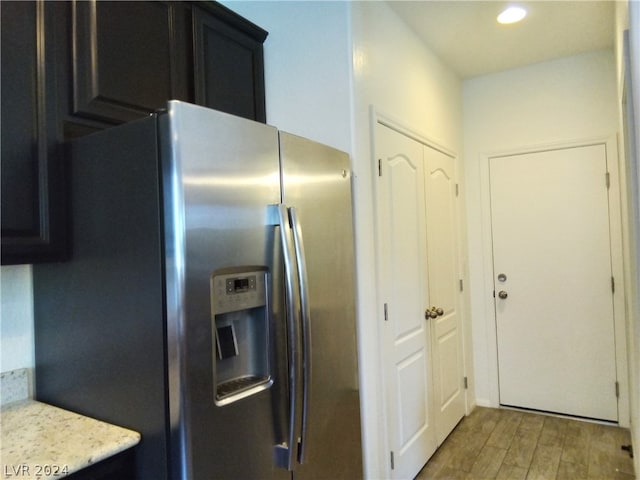 kitchen featuring stainless steel fridge and light wood-type flooring