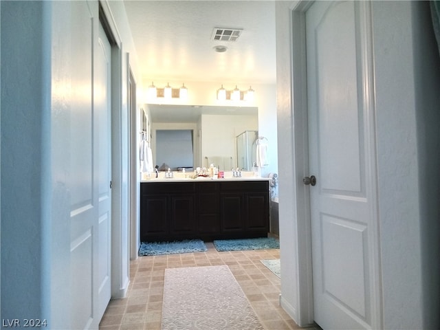 bathroom with tile patterned floors and double sink vanity