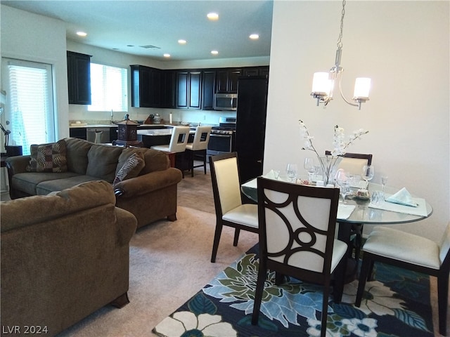 carpeted living room featuring an inviting chandelier