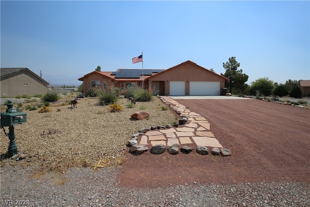 ranch-style home featuring solar panels