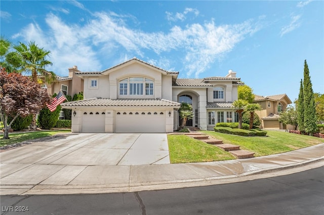 mediterranean / spanish house with a garage