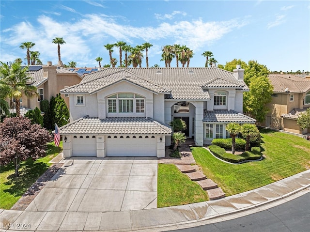 mediterranean / spanish-style home with a garage and a front yard