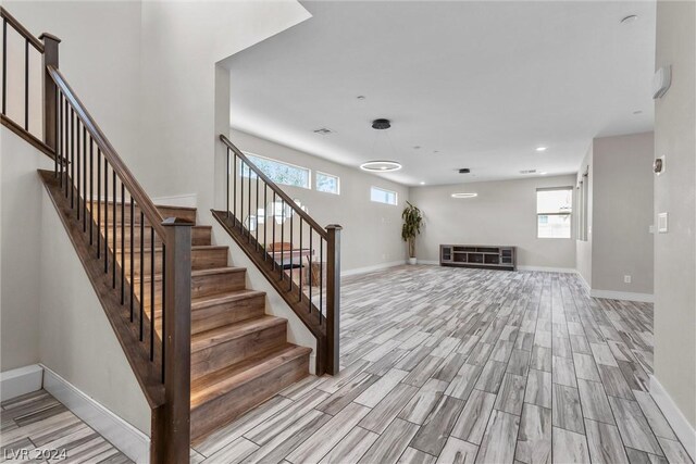 stairs with light hardwood / wood-style flooring