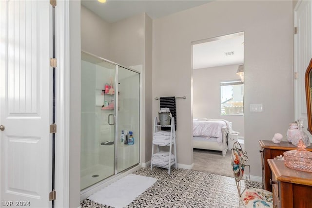 ensuite bathroom featuring baseboards, ensuite bath, and a shower stall